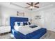 Main bedroom with a large, tufted blue headboard and tray ceiling at 3143 Bonnes Dr, Stonecrest, GA 30038
