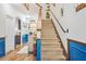 Carpeted staircase with wood banister leading to the upper level of the home at 3143 Bonnes Dr, Stonecrest, GA 30038
