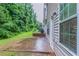 A shady backyard featuring a patio and exterior siding at 541 Shadow Valley Ct, Lithonia, GA 30058