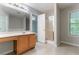 Bright bathroom features glass shower, large mirror, and ample counterspace at 541 Shadow Valley Ct, Lithonia, GA 30058