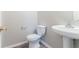 Powder bathroom with pedestal sink, modern fixtures, and neutral colors at 541 Shadow Valley Ct, Lithonia, GA 30058