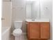 A well-lit bathroom with a vanity, toilet, shower-tub combo and neutral decor at 541 Shadow Valley Ct, Lithonia, GA 30058