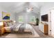 Bright bedroom with vaulted ceilings, ceiling fan, plush rug, and sunny windows at 541 Shadow Valley Ct, Lithonia, GA 30058