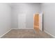Bedroom features neutral walls, plush carpeting, and multiple entryways at 541 Shadow Valley Ct, Lithonia, GA 30058