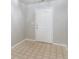 Simple entrance area features neutral walls and beige vinyl tile flooring at 541 Shadow Valley Ct, Lithonia, GA 30058