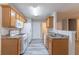 Kitchen features modern appliances, grey vinyl floors, and neutral tones at 541 Shadow Valley Ct, Lithonia, GA 30058