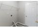 A functional laundry room with shelving, door and utility hookups at 541 Shadow Valley Ct, Lithonia, GA 30058