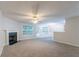 Spacious living room with plush carpet, fireplace, and natural light at 541 Shadow Valley Ct, Lithonia, GA 30058