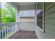 Covered porch offers an outdoor living space with privacy railing and wooded view at 541 Shadow Valley Ct, Lithonia, GA 30058