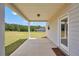 Covered back porch with concrete floor, adjacent to wide open backyard with meadow view at 715 Colvin Dr, Locust Grove, GA 30248