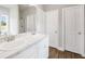 Bright bathroom featuring a double vanity with marble countertop, and wood look floors at 715 Colvin Dr, Locust Grove, GA 30248
