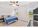 Cozy bedroom with large windows, ceiling fan, and neutral carpet at 715 Colvin Dr, Locust Grove, GA 30248