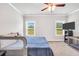 Sunlit bedroom features plush carpet and two large windows at 715 Colvin Dr, Locust Grove, GA 30248
