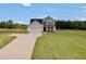 Inviting two-story home on a sprawling lawn with a long driveway at 715 Colvin Dr, Locust Grove, GA 30248