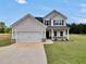 Charming two-story home with a two-car garage and well-manicured lawn at 715 Colvin Dr, Locust Grove, GA 30248