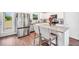 Modern kitchen with stainless steel refrigerator, white cabinetry and granite countertops at 715 Colvin Dr, Locust Grove, GA 30248