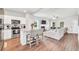 Open floor plan kitchen and living room with a fireplace and a ceiling fan at 715 Colvin Dr, Locust Grove, GA 30248