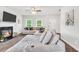 Bright living room with a cozy fireplace and a comfortable sectional sofa at 715 Colvin Dr, Locust Grove, GA 30248