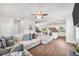 Spacious living room with hardwood floors, connected to an open-concept kitchen at 715 Colvin Dr, Locust Grove, GA 30248