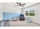 Cozy room with gray furniture and blue board and batten accent wall at 715 Colvin Dr, Locust Grove, GA 30248