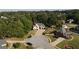 Aerial view of homes in a green lush neighborhood with mature trees and well manicured lawns at 255 Carriage Station Dr, Lawrenceville, GA 30046