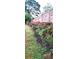 Landscaped backyard with blooming bushes and a wooden fence at 255 Carriage Station Dr, Lawrenceville, GA 30046