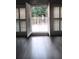 A naturally lit balcony door with white shutters overlooks an exterior deck with decorative railings at 255 Carriage Station Dr, Lawrenceville, GA 30046