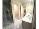 Bright bathroom featuring a glass shower and a vanity with white countertop and sinks at 255 Carriage Station Dr, Lawrenceville, GA 30046