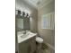 Cozy powder room features modern vanity, marble countertop, and sleek fixtures at 255 Carriage Station Dr, Lawrenceville, GA 30046