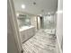 Spacious bathroom with a double sink vanity, glass shower, and distressed wood-look flooring at 255 Carriage Station Dr, Lawrenceville, GA 30046