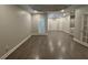Open bedroom with tray ceiling, shutters, light walls, and wood flooring at 255 Carriage Station Dr, Lawrenceville, GA 30046