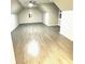 Upstairs bonus room with wood flooring, shutters, and ceiling fan at 255 Carriage Station Dr, Lawrenceville, GA 30046