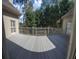 View from inside of a gray stained deck with custom railings and green foliage surrounding the home at 255 Carriage Station Dr, Lawrenceville, GA 30046