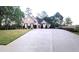 Beautiful exterior view of a brick home, expansive driveway, and well-maintained lawn and landscaping at 255 Carriage Station Dr, Lawrenceville, GA 30046
