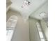 Close-up of an elegant crystal chandelier hanging above the entryway, with high ceilings and bright windows at 255 Carriage Station Dr, Lawrenceville, GA 30046