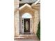 Close-up of the front door with an oval glass insert, sidelights, and brick detailing, enhancing curb appeal at 255 Carriage Station Dr, Lawrenceville, GA 30046