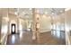 Expansive great room boasts soaring ceilings, hardwood floors, grand pillars, and elegant chandeliers at 255 Carriage Station Dr, Lawrenceville, GA 30046