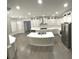 Bright kitchen boasts white cabinetry, stainless appliances, and a marble countertops at 255 Carriage Station Dr, Lawrenceville, GA 30046