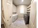 Well-lit laundry room with modern cabinets, countertops, and stainless steel washer and dryer at 255 Carriage Station Dr, Lawrenceville, GA 30046