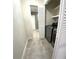 Convenient laundry area with modern washer/dryer, storage, and tile flooring, located near the bathroom at 255 Carriage Station Dr, Lawrenceville, GA 30046