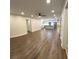 Open-concept living space with wood floors flowing into a modern kitchen with stainless steel appliances at 255 Carriage Station Dr, Lawrenceville, GA 30046
