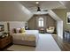 A bright main bedroom features a ceiling fan, accent pillows, and an arched window with plantation shutters at 255 Carriage Station Dr, Lawrenceville, GA 30046