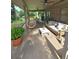 A covered porch offers outdoor seating, a unique hanging chair, and views of the private backyard at 255 Carriage Station Dr, Lawrenceville, GA 30046
