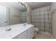 A bathroom with double sinks, white cabinets, and a shower curtain at 118 Brendylynn Trce, Woodstock, GA 30188