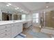 Bathroom featuring a double sink vanity with a large mirror and a glass-enclosed shower at 118 Brendylynn Trce, Woodstock, GA 30188
