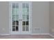 View of the French doors in this neutral carpeted room at 118 Brendylynn Trce, Woodstock, GA 30188