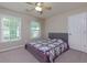 Bedroom with neutral walls, carpet, a ceiling fan, and natural light from the large windows at 118 Brendylynn Trce, Woodstock, GA 30188