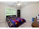 A cozy bedroom with a ceiling fan, a large window, and carpet at 118 Brendylynn Trce, Woodstock, GA 30188