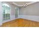 Dining room with hardwood floors, wainscoting, chandelier, and large windows at 118 Brendylynn Trce, Woodstock, GA 30188