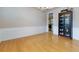 Dining room featuring hardwood floors, wainscoting, a dark curio cabinet and a view into the kitchen at 118 Brendylynn Trce, Woodstock, GA 30188